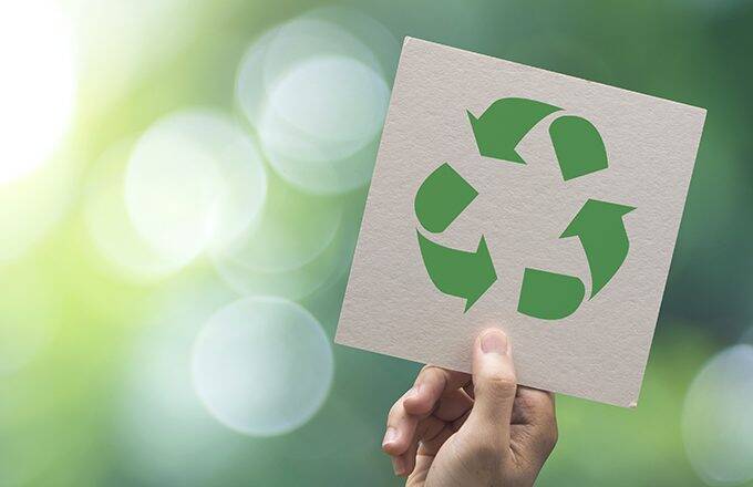 hand holding a recycling symbol