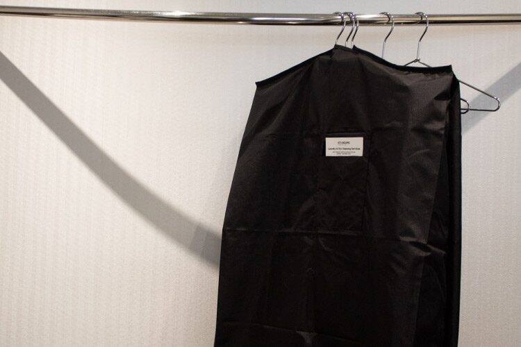 VersaValet garment bag with clean clothing hanging in a hotel closet