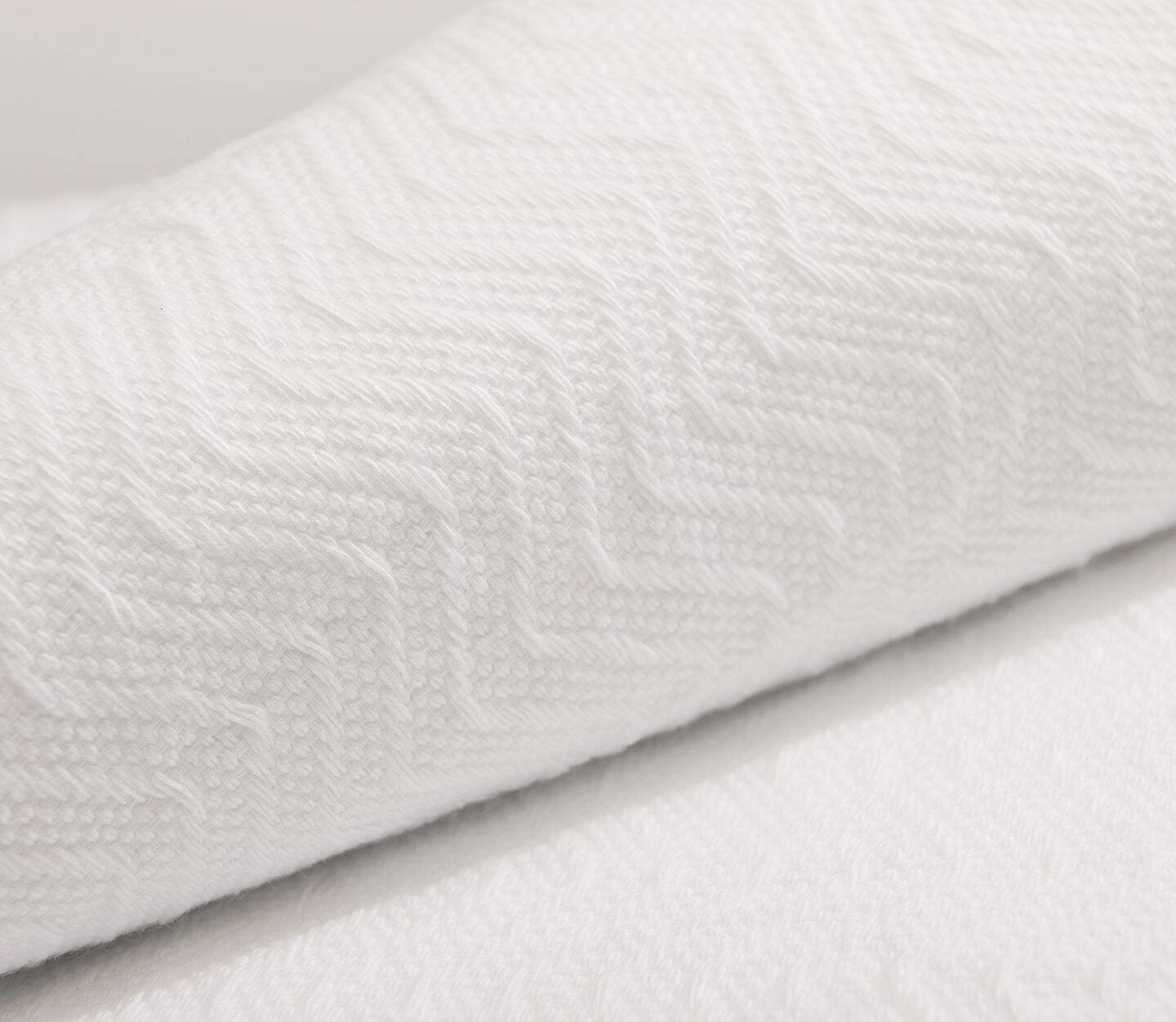 A detail of the textural herringbone blanket. These blankets are known to be breathable blankets.