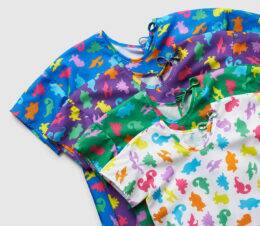 A stack of our full collection of DinoDreams pediatric gowns