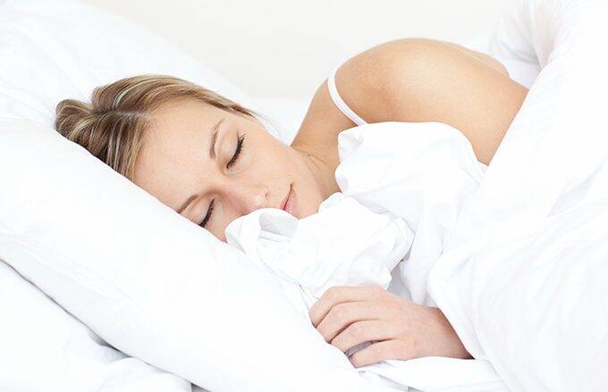 lady sleeping soundly in comfortable hotel sheets